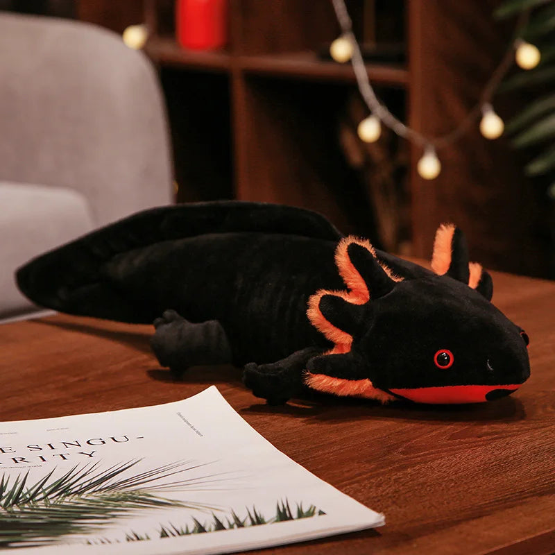 Cute Axolotl Plush Toy – Squishmallow Salamander Stuffed Animal Plush axolotl toy on a wooden surface with a magazine underneath