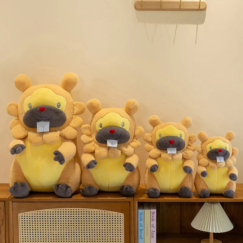 Pokemon Bidoof Plush Toy – Cute Sleeping Stuffed Animal Pillow Four yellow and brown beaver plush toys of different sizes arranged on a wooden cabinet against a beige wall.