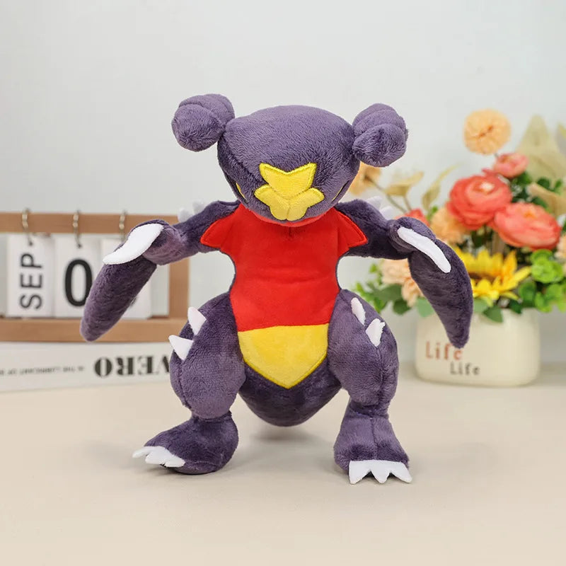 Pokemon Garchomp Plush Toy – Garchomp, Gabite & Gible Stuffed Animal Plush toy resembling a purple creature with red and yellow accents on a light surface.