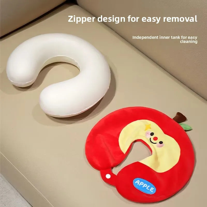 Cute Capybara U-Shaped Neck Pillow – Plush Travel Pillow Two soft U-shaped neck pillows displayed on a beige upholstered surface: one plain white and one red apple-shaped with a yellow face and small green stem. White text at the top reads 'Zipper design for easy removal' and 'Independent inner tank for easy cleaning.