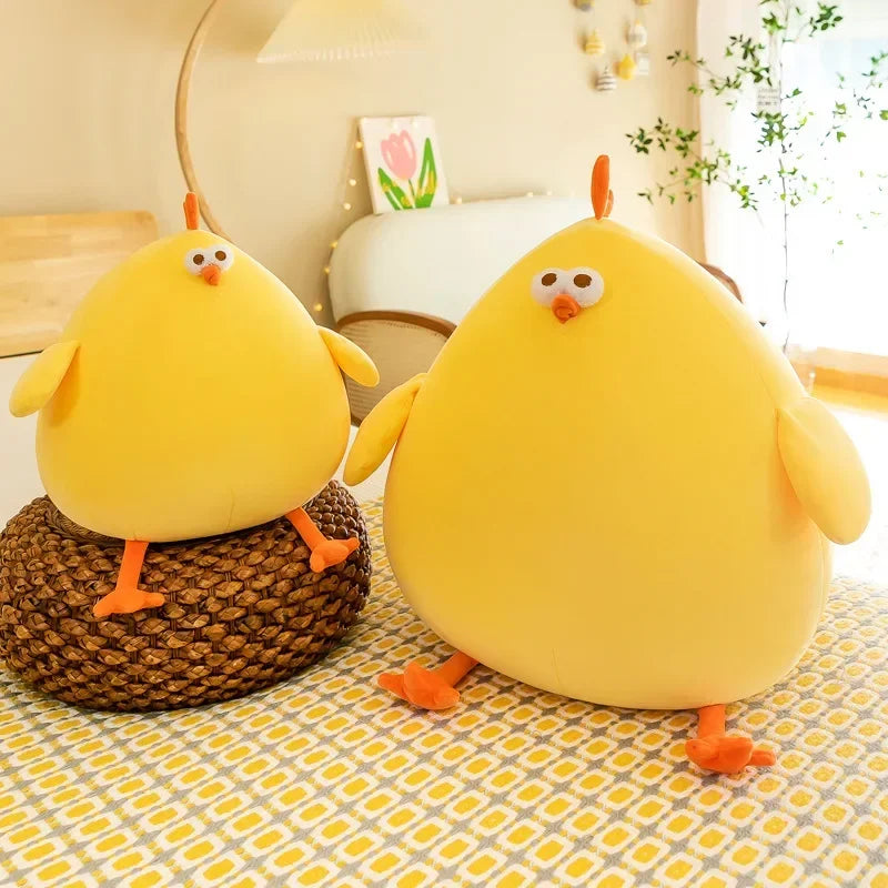 Squishmallow Fat Chicken Plush Toy Stuffed Animal Two yellow plush chickens on a patterned surface with a blurred indoor background