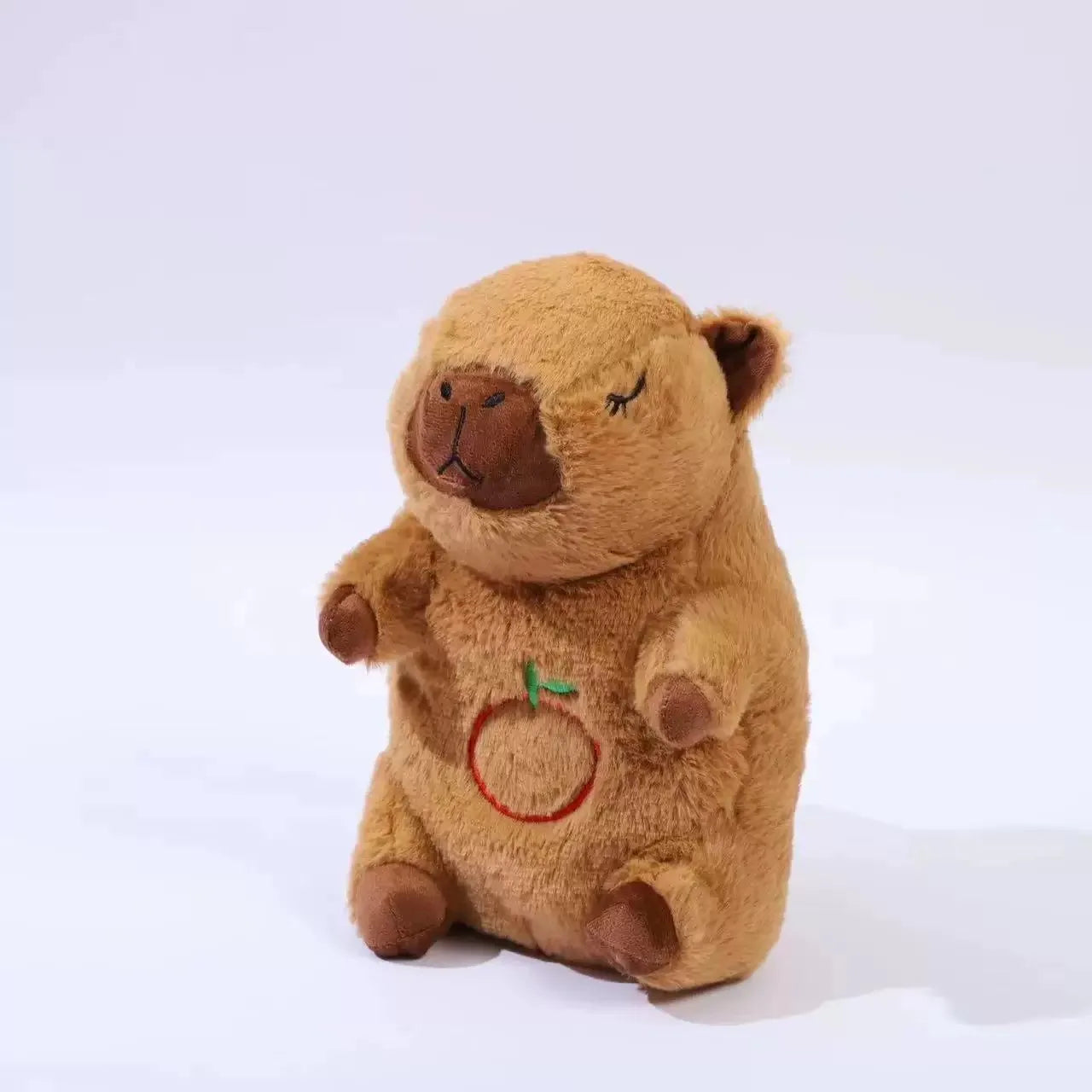 Breathing Capybara Plush Toy with Light & Sound Brown teddy bear with a red circle and green leaf on a white background
