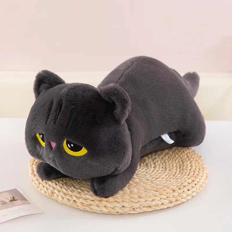 Black Cat Plush Pillow – Cute Kawaii Stuffed Animal Cushion Gray plush cat toy with yellow eyes on a woven mat