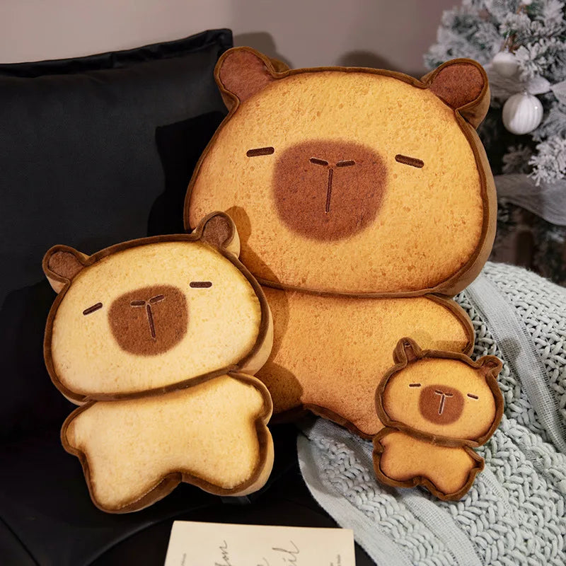 Capybara Bread Pillow – Cute Toast Plush Cushion Two bear-shaped cushions on a dark surface with a blurred background