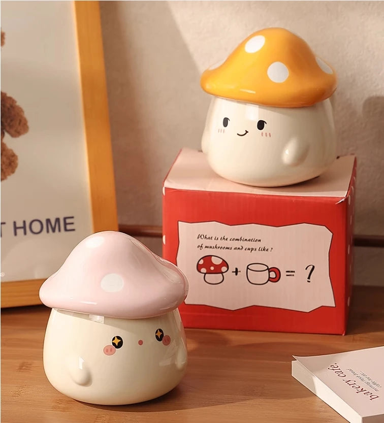 Cute Mushroom Coffee Mug with Lid – 400ML Ceramic Cup Two cute mushroom-shaped ceramic cups on a wooden surface with a red box in the background.