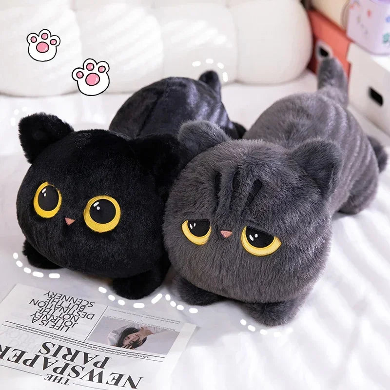 Black Cat Plush Pillow – Cute Kawaii Stuffed Animal Cushion Two plush cat toys, one black and one gray, on a surface with a newspaper underneath.