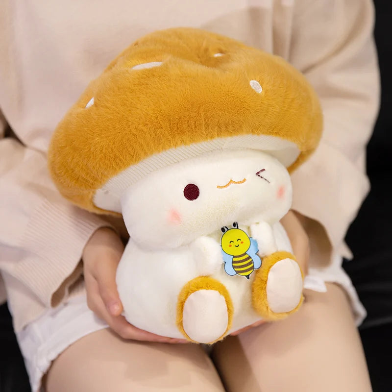 Creative Mushroom Plush Pillow – Cute Stuffed Plant Cushion for Home Décor Plush toy shaped like a cartoon character inside a hamburger with a bee on its chest, held by a person.