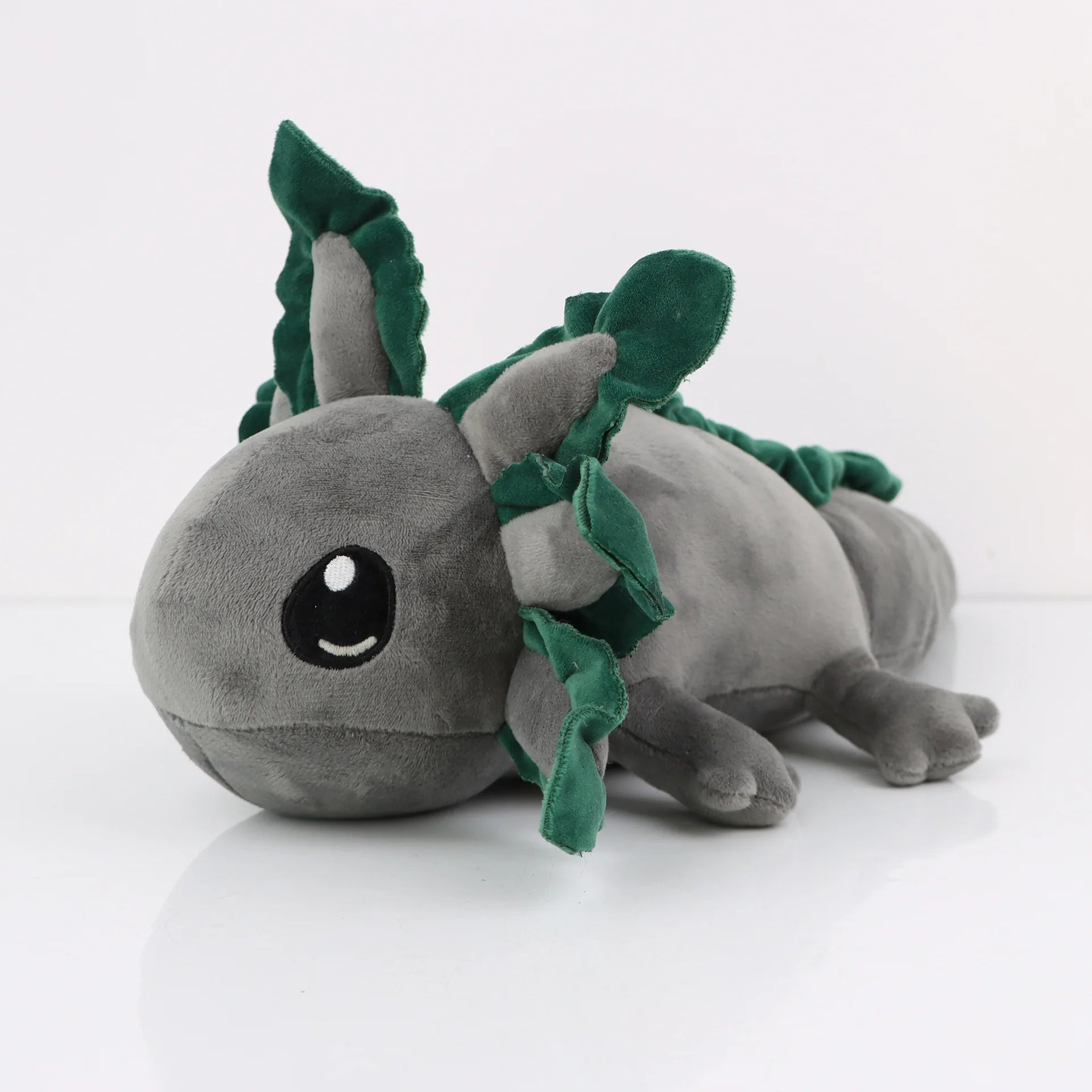 Axolotl Squishmallow Plush Toy – Soft Stuffed Animal Plush toy axolotl with green leaves on a white background