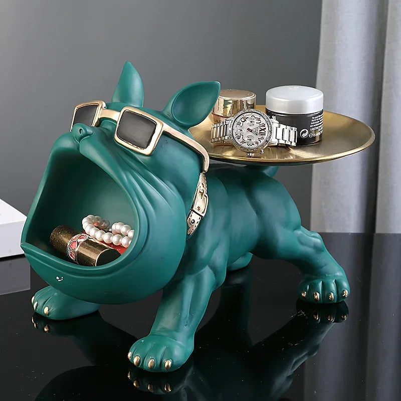 Bulldog Figurine with Storage Box – Resin Dog Home Decor Sculpture Teal bulldog-shaped jewelry stand with a gold tray on a dark surface.