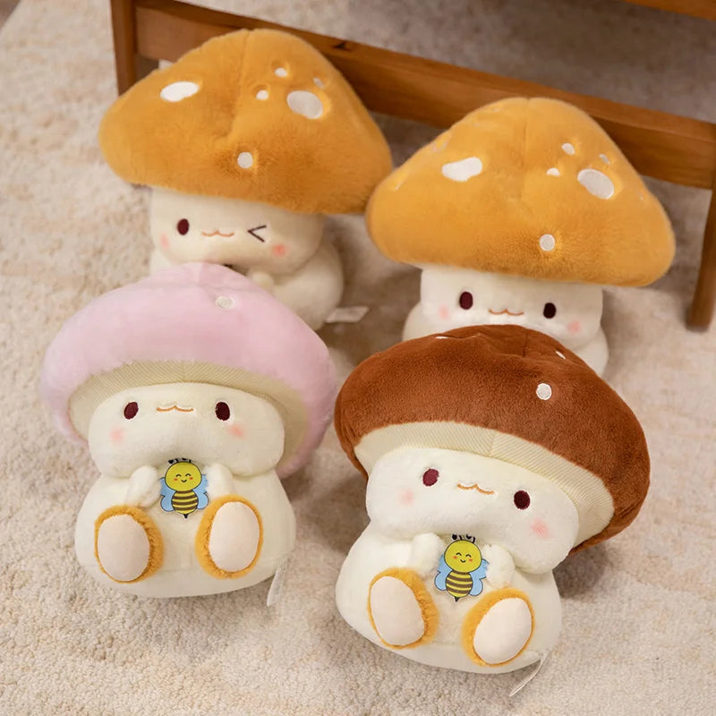 Creative Mushroom Plush Pillow – Cute Stuffed Plant Cushion for Home Décor Four cute plush mushroom toys with cartoon faces on a beige surface.