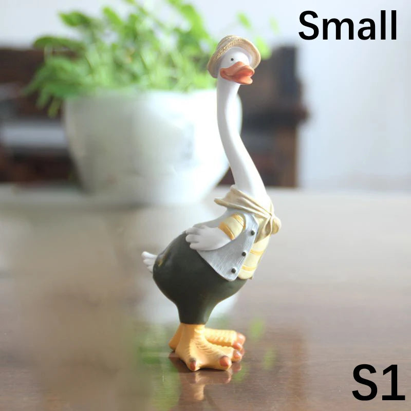 Resin Duck Family Garden Statue – Animal Outdoor Decor Sculpture Decorative goose figurine with a hat on a reflective surface, with 'Small' and 'S1' text.