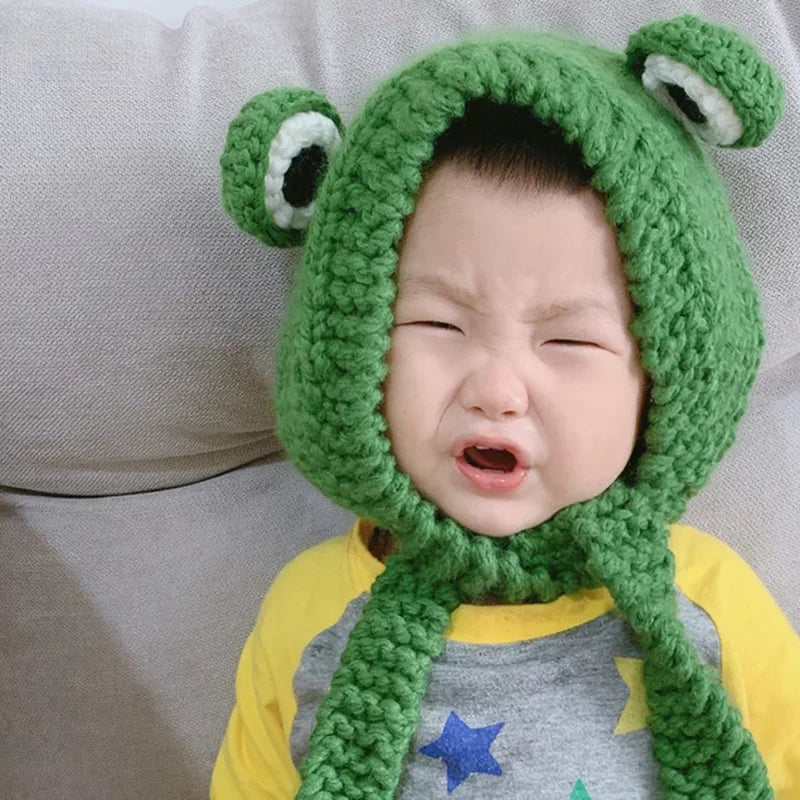 Cute Green Frog Crochet Beanie Hat – Knitted Winter Costume Cap Baby wearing a green frog hat with a neutral background