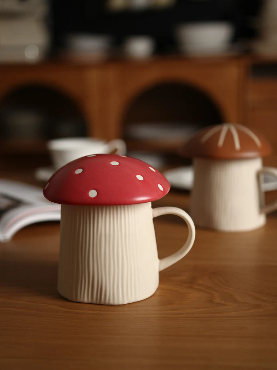 Mushroom Coffee Mug with Lid – Cute Drinking Cup Two ceramic mugs shaped like mushrooms on a wooden surface.