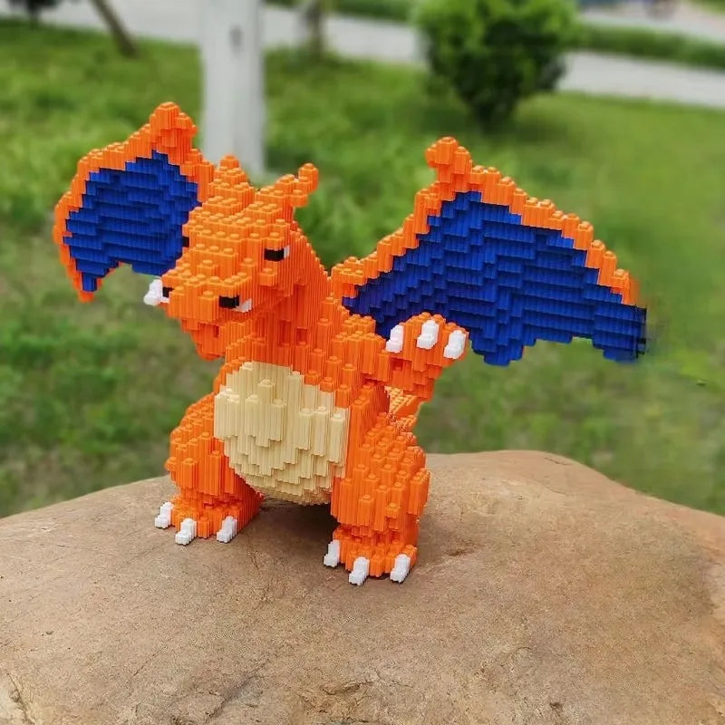 Pokemon Fire-Breathing Dragon Building Blocks – Model Brick Toy Toy figure of a dragon-like creature made from interlocking bricks on a rock with a blurred green outdoor background