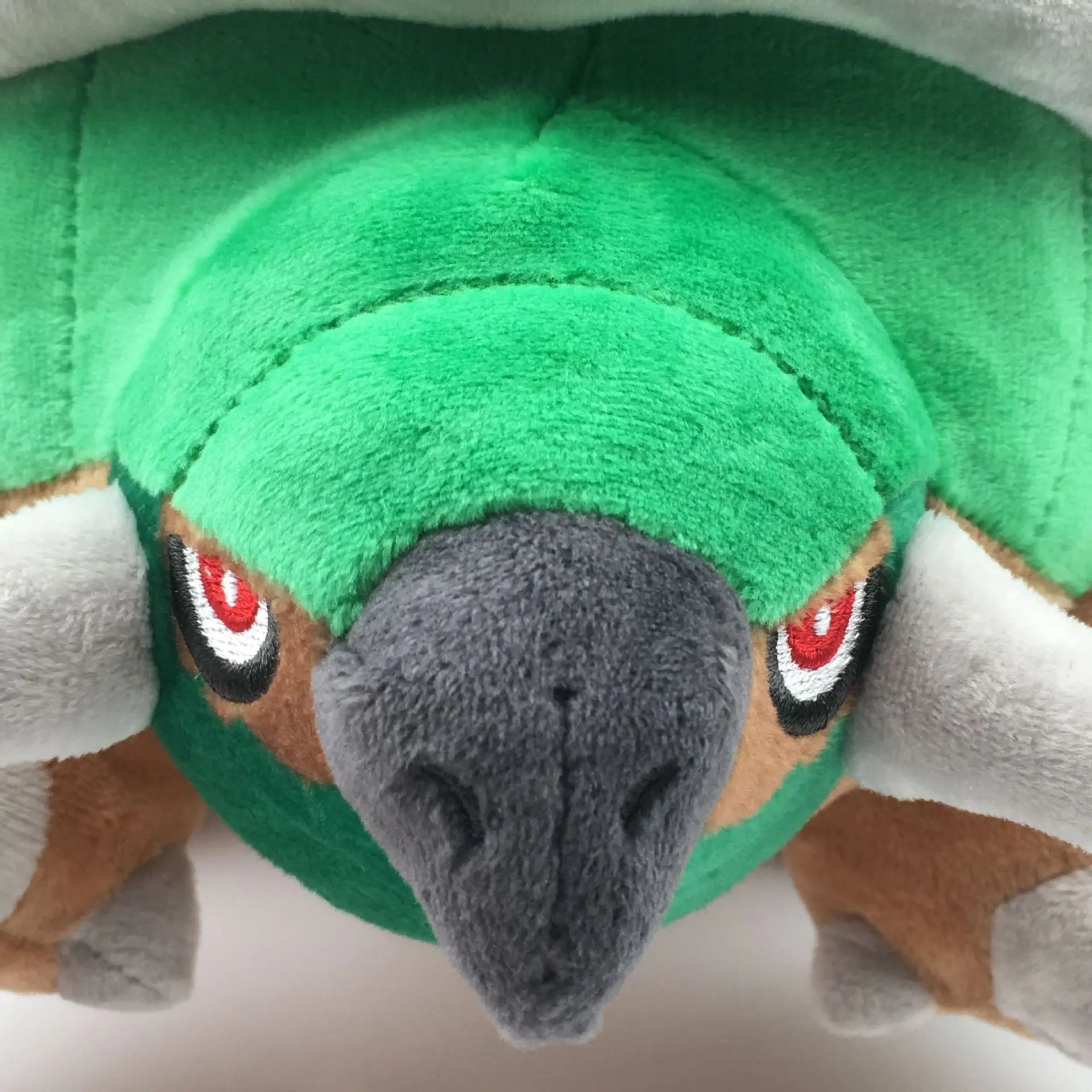 Pokemon Torterra Plush Toy – Turtwig Evolution Stuffed Doll Close-up of a green plush toy with red eyes and gray nose on a white background