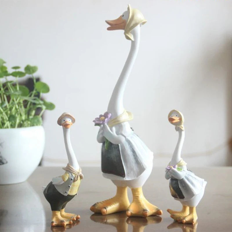 Resin Duck Family Garden Statue – Animal Outdoor Decor Sculpture Decorative goose figurines with a plant in the background