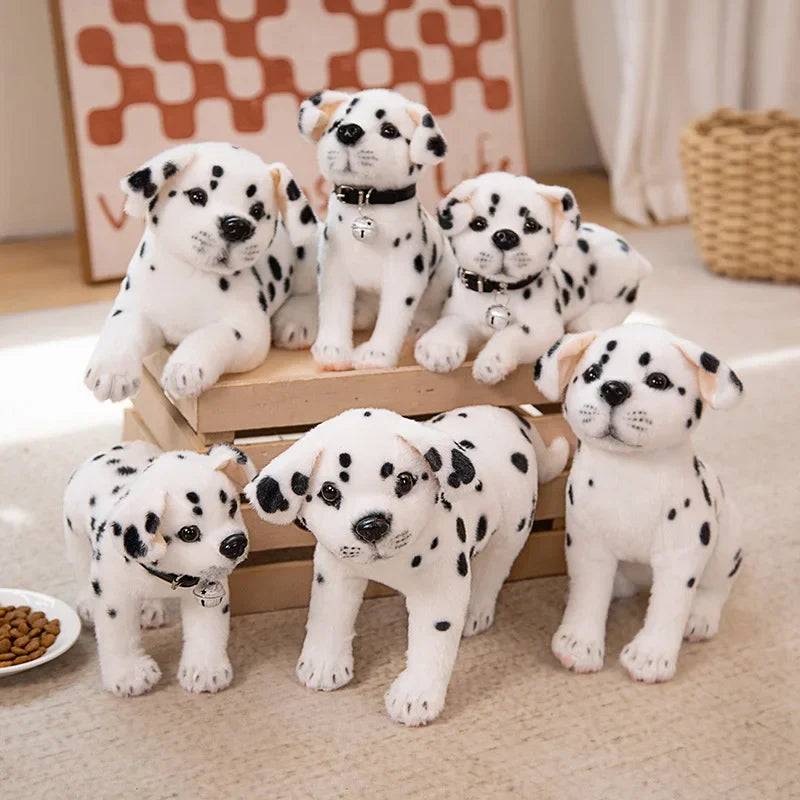 Realistic Dalmatian Beagle Plush Stuffed Toy Six plush Dalmatian puppy toys in white with black spots, arranged on and around a small wooden crate in a softly lit indoor setting.