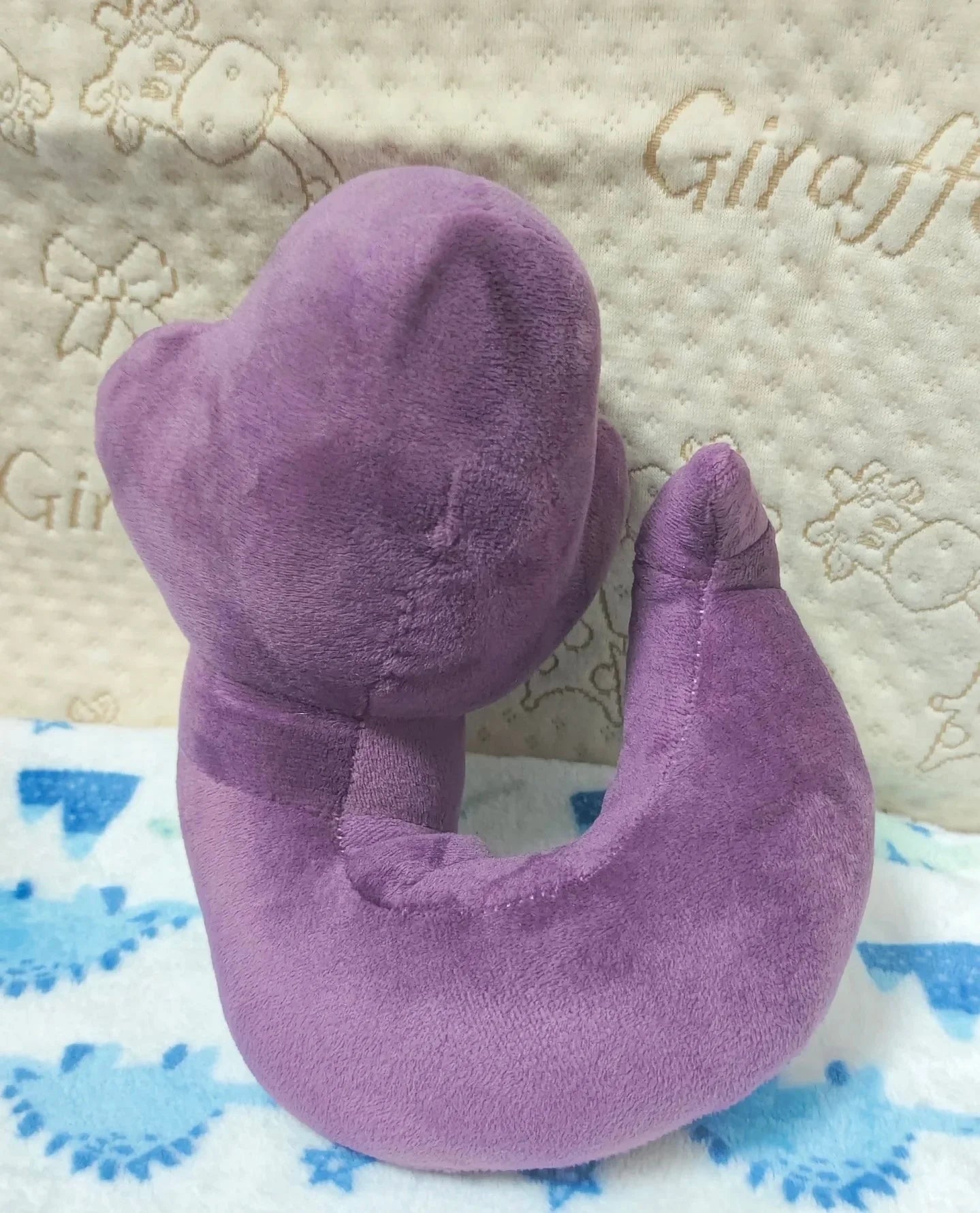Pokemon Arbok Plush Toy – Ekans Evolution Stuffed Animal Purple plush neck pillow on a textured fabric background