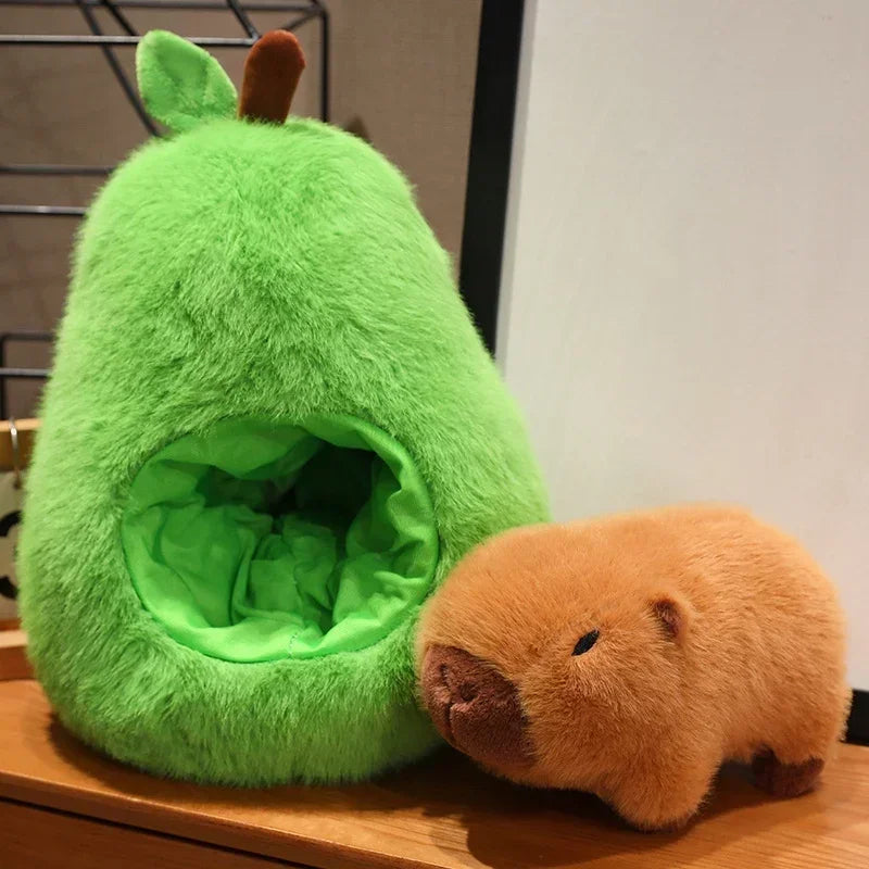 Avocado Capybara Plush Toy – Cute Soft Pillow Green plush pet bed with a small brown plush animal next to it on a wooden surface.