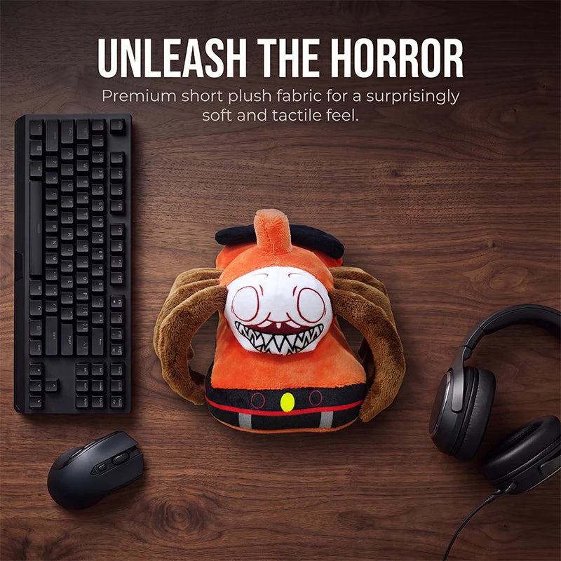 Horror Spider Plush Dolls – 2-Piece Creepy Halloween Set An orange horror-themed plush toy with brown spider-like arms and a white face sits on a dark wood desk, surrounded by a keyboard, mouse, and headphones. Text at the top reads 'UNLEASH THE HORROR' with smaller descriptive copy.