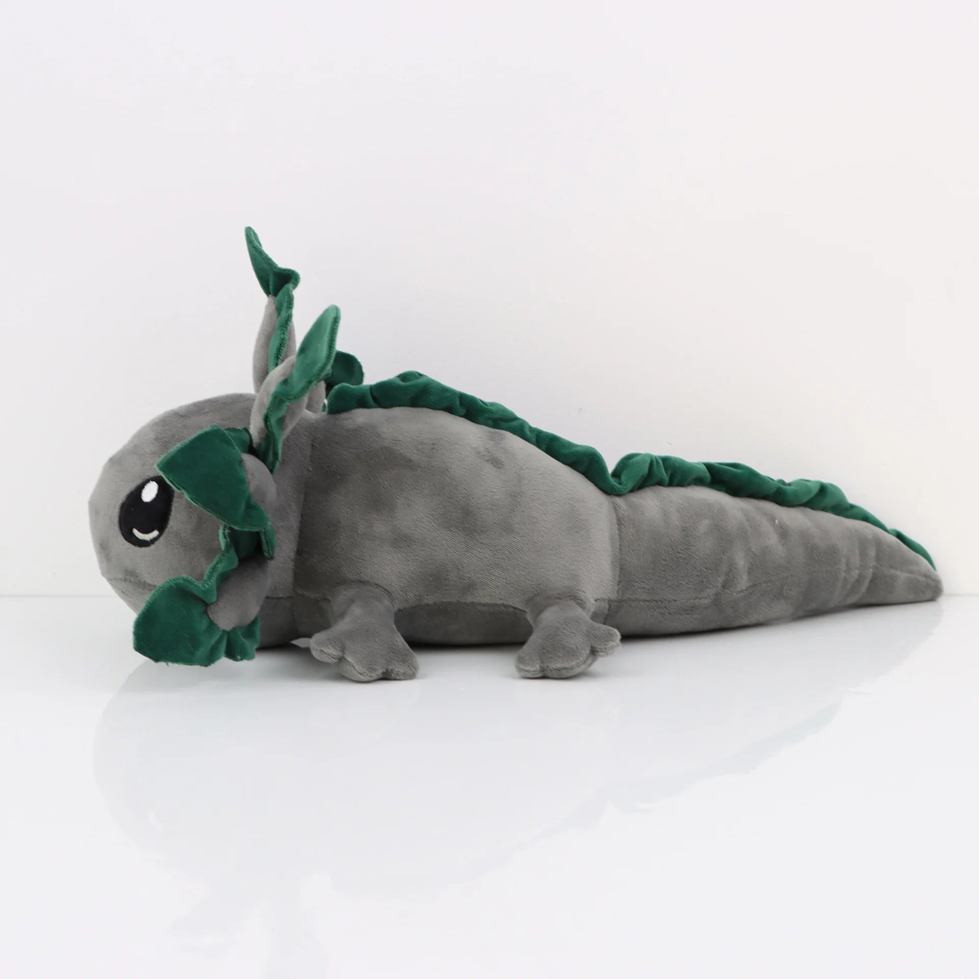 Axolotl Squishmallow Plush Toy – Soft Stuffed Animal Gray plush toy with green leaf-like appendages on a white background