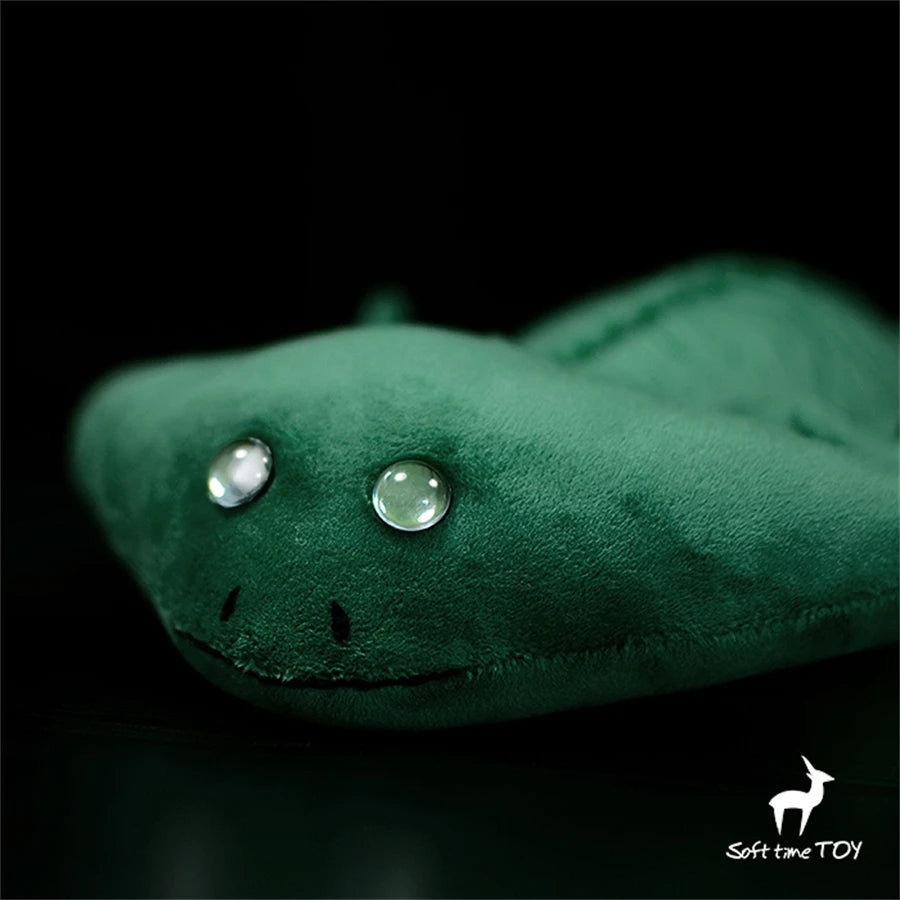 Realistic Axolotl Hammerhead Salamander Stuffed Toy - Diplocaulus Plushie Green plush toy with glowing eyes on a black background, branded 'Soft Time Toy'.