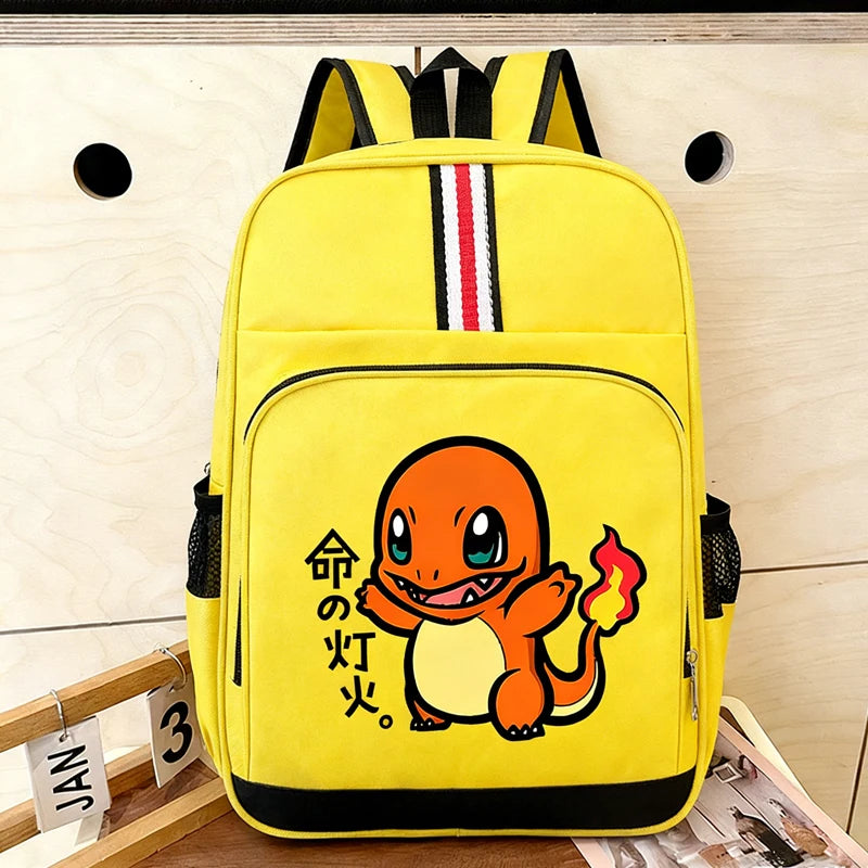 Pokemon Cartoon Backpack – Large Capacity School Bag A bright yellow backpack featuring a cartoon Charmander graphic on the front pocket, with black trim, side mesh pockets, and a vertical red, white, and black stripe near the top. The backpack is photographed against a light wood wall with a small wooden calendar prop at the lower left.