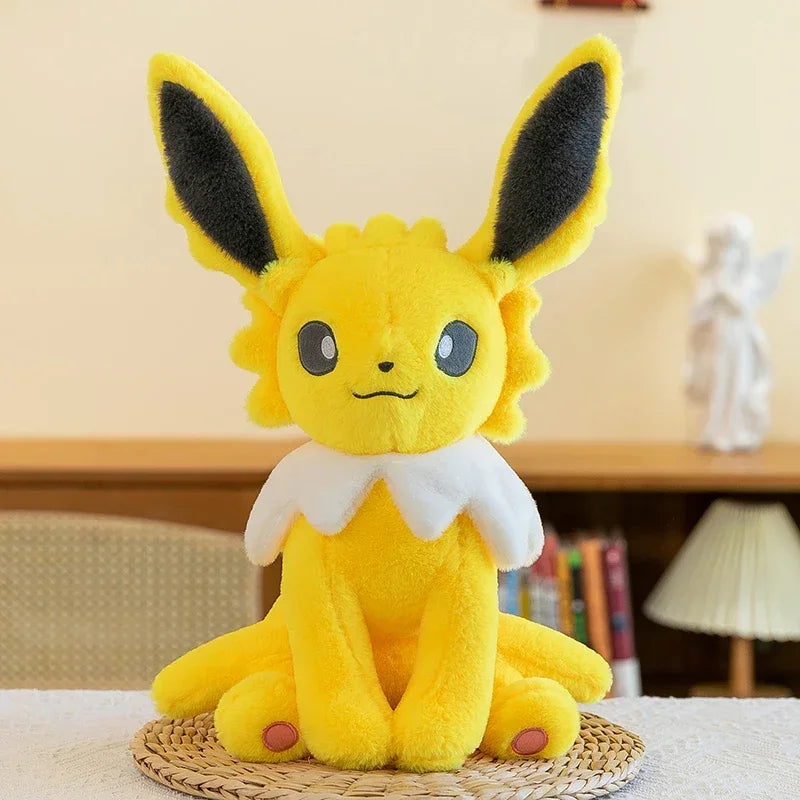 Pokemon Eevee Plush Toy – Vaporeon, Flareon & Jolteon Soft Stuffed Animal Yellow plush toy with large ears on a woven mat