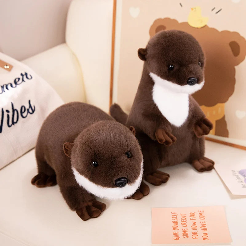 Realistic Otter Plush Toy Two plush otters on a couch with a decorative pillow and wall art in the background.