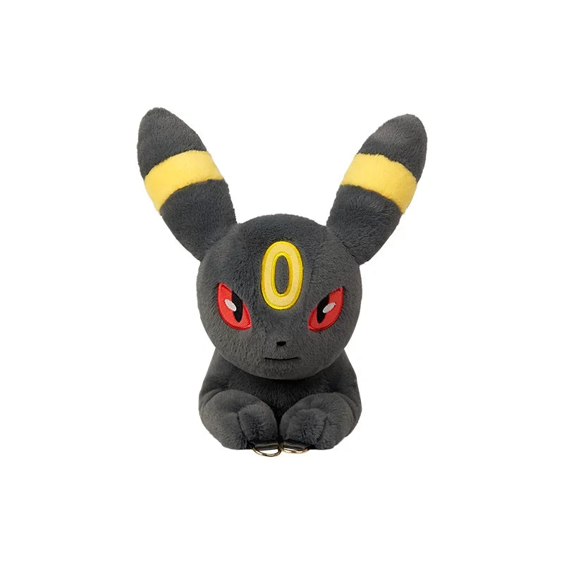 Pokemon Eevee Evolution Plush Crossbody Bag A plush toy of Umbreon, a dark gray Pokémon with yellow stripes on its ears and a yellow crescent on its forehead, sitting against a plain white background.