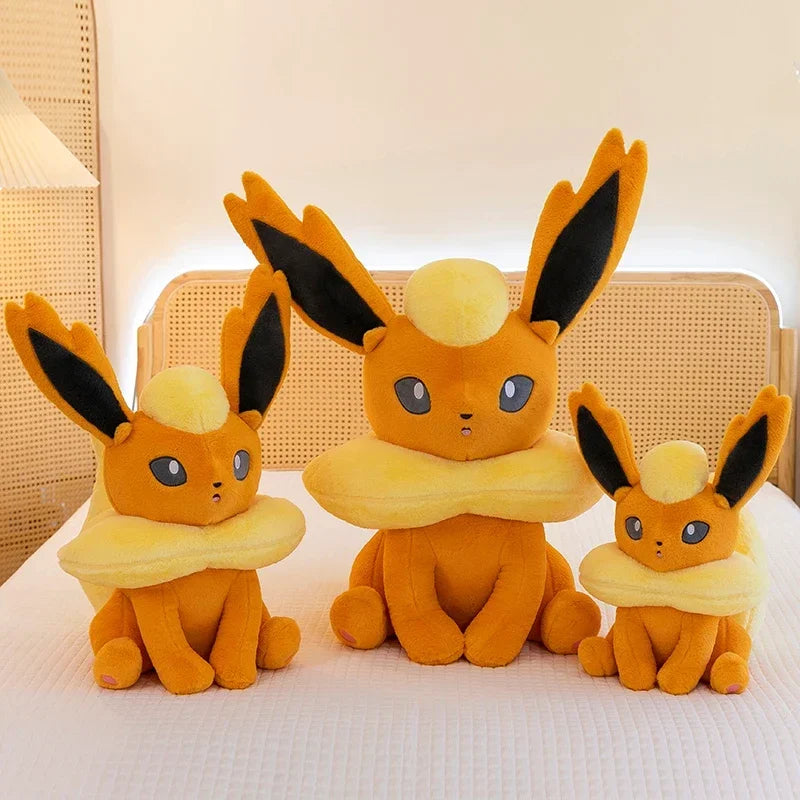 Pokemon Eevee Plush Toy – Vaporeon, Flareon & Jolteon Soft Stuffed Animal Three Eevee plush toys of different sizes on a light background