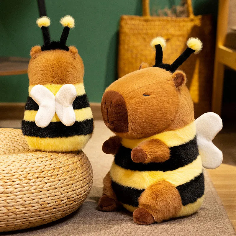 Bee Capybara Plush Toy – Kawaii Soft Stuffed Animal Two plush bee toys sitting on a woven chair and floor.