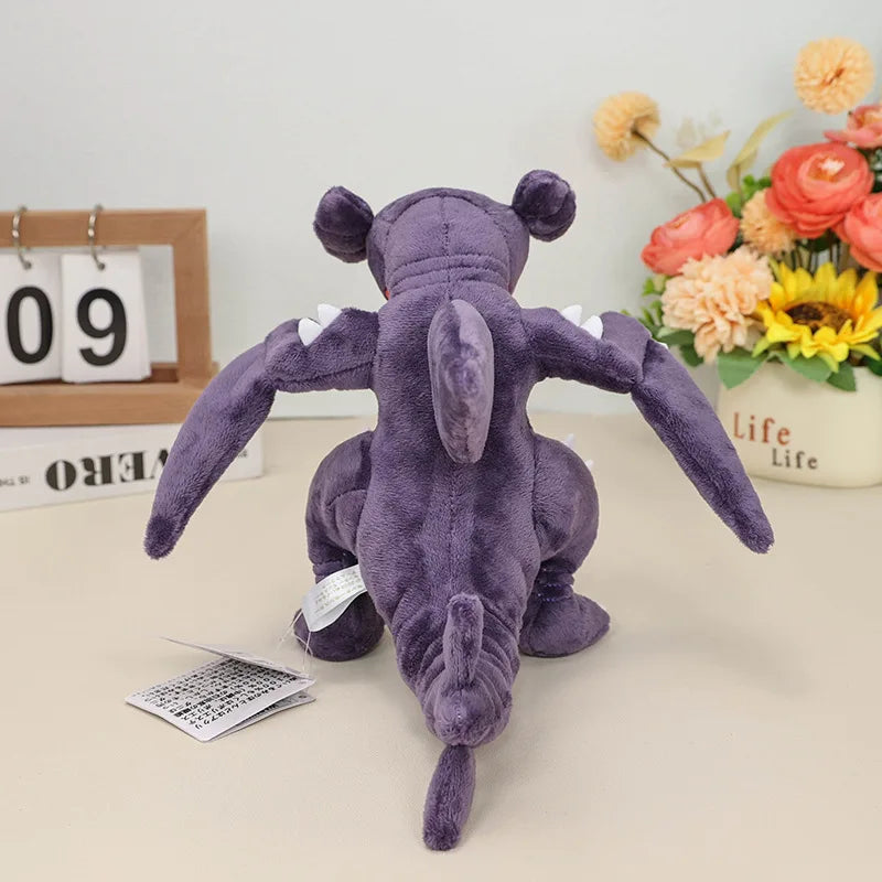 Pokemon Garchomp Plush Toy – Garchomp, Gabite & Gible Stuffed Animal Purple plush toy on a table with a calendar and flowers in the background