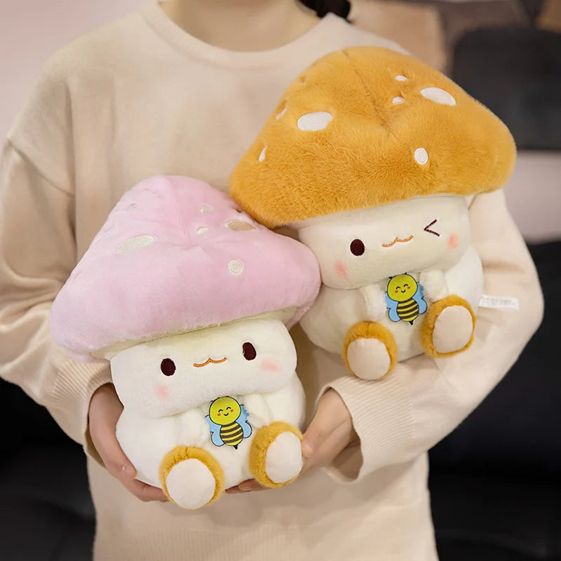 Creative Mushroom Plush Pillow – Cute Stuffed Plant Cushion for Home Décor Two plush mushroom toys held by a person wearing a beige sweater.