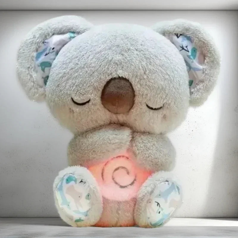 Baby Breathing Otter Plush with Light & Sound Plush toy koala with a glowing heart at its chest on a light background