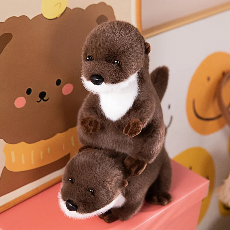 Realistic Otter Plush Toy Two plush otters on a pink stand with a cartoon bear in the background