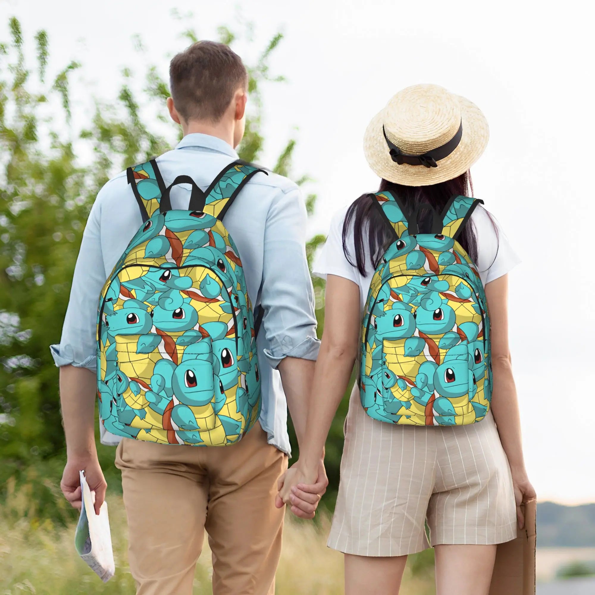 Pokemon Squirtle Backpack – Sport School Bag A man and a woman walking away outdoors, each wearing a matching backpack printed with a repeating cartoon turtle pattern in teal, yellow, and brown. The man wears a light blue shirt and tan pants, and the woman wears a white shirt, beige shorts, and a straw hat.