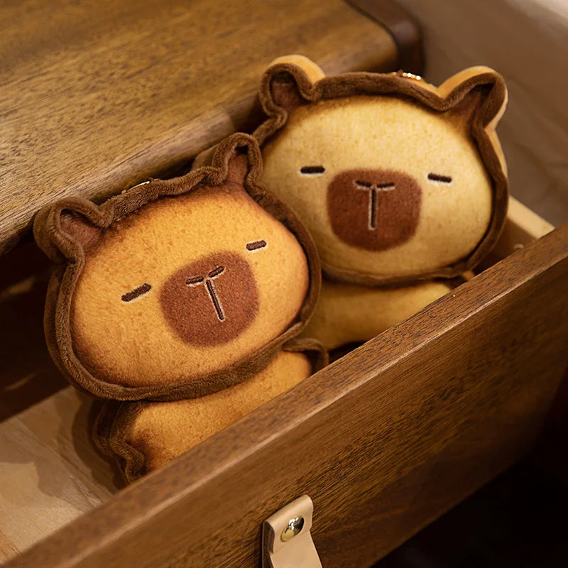 Capybara Bread Pillow – Cute Toast Plush Cushion Two bear-shaped cookies in a wooden box on a wooden surface