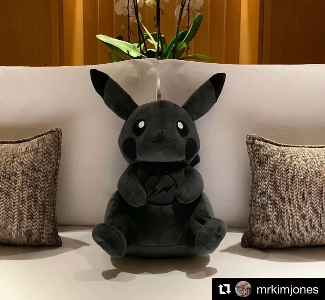 Dark Pikachu Plush Pillow Black Kawaii Doll Black plush toy resembling a popular character on a white couch with pillows and a plant.