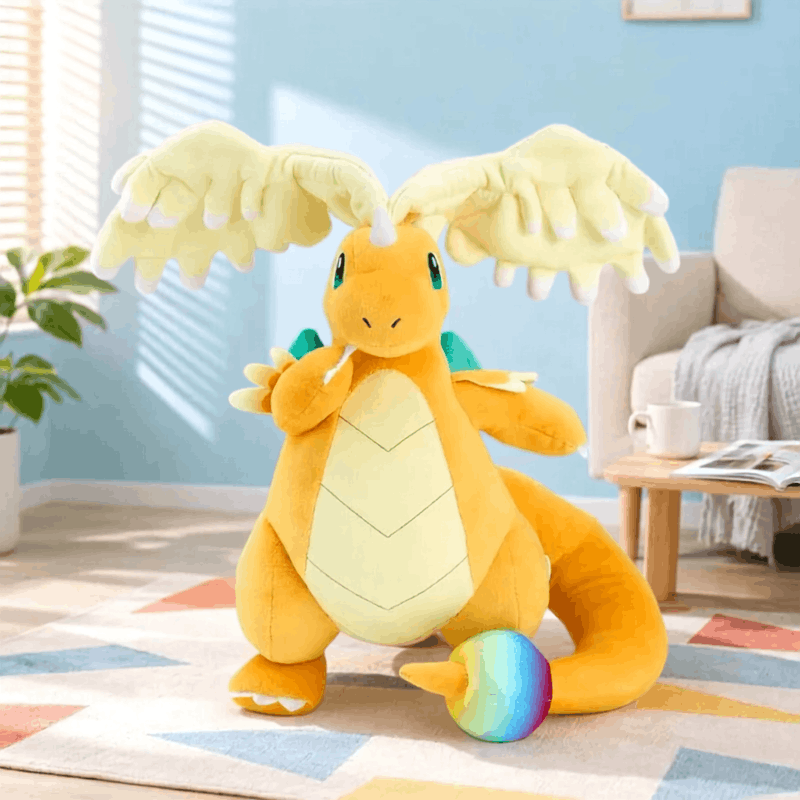 Pokemon Dragonite Plush Toy – Large Soft Stuffed Doll A large yellow and orange plush toy dragon with spread wings sits on a patterned rug in a bright living room. A small rainbow ball is in front of it, and a couch, side table, plant, and window blinds are visible in the background.