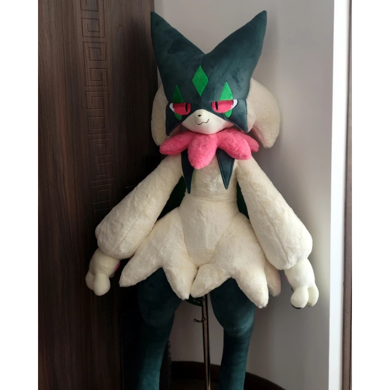 Pokemon Meowscarada Plush Pillow Stuffed Toy A large plush toy of a dark teal and cream-colored Pokémon character with a pink bow, standing on a stand in an indoor corner.