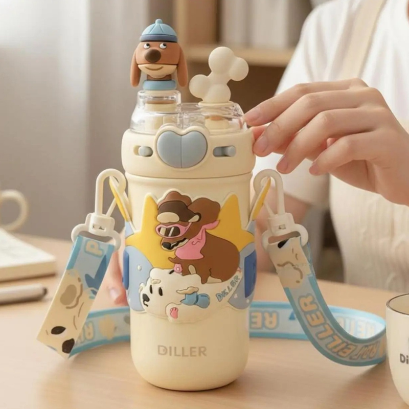 Capybara Insulated Tumbler – Cute Cartoon Water Bottle A cute cream-colored water bottle with cartoon dog graphics, a blue strap, and a small dog figure on top, shown on a table with a person's hand adjusting the lid.