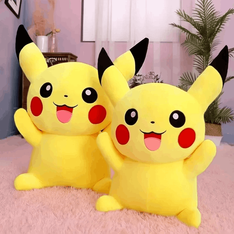 Pokemon Pikachu Plush Toy – Kawaii Soft Stuffed Animal Cushion Two yellow Pikachu plush toys with black-tipped ears and red cheeks, posed together on a pink rug in a styled indoor room with a plant and soft pink walls.