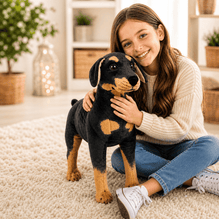 Woman holding a large black and brown dog plush toy in a cozy living room.