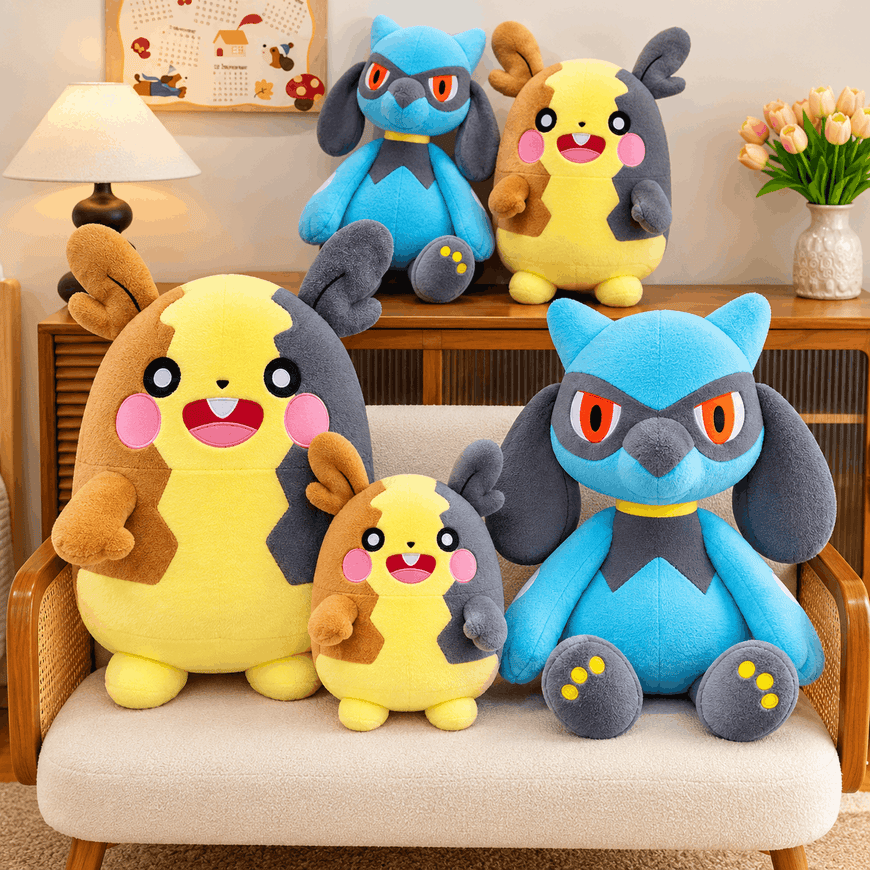 A set of Pokémon plush toys arranged in a cozy living room setting, including two large and two small Pichu plushies and two blue and gray Togepel plushies. The toys are styled on a beige upholstered sofa and a wooden cabinet against a warm beige wall.
