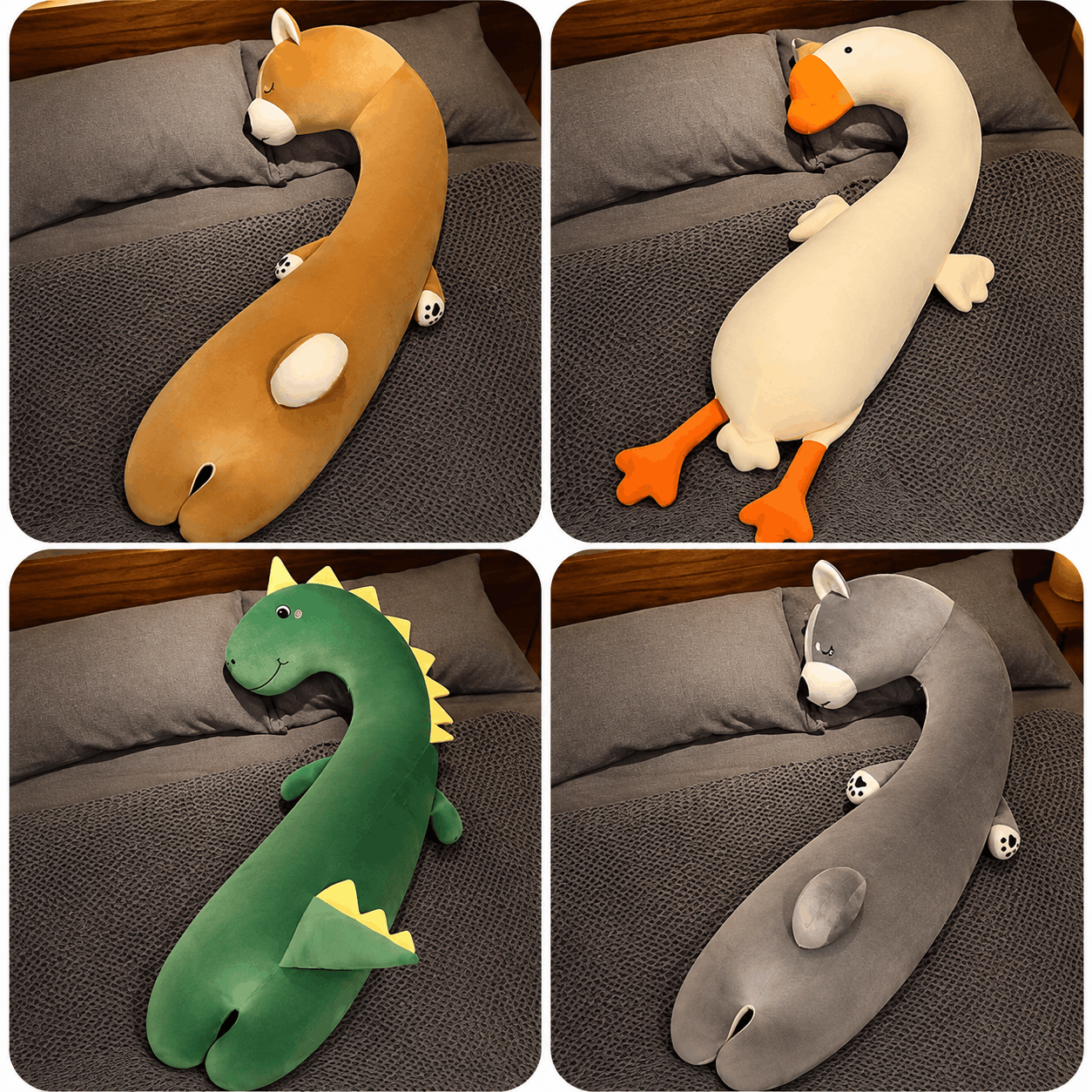 Four plush animal-shaped long pillows arranged in a 2x2 grid on a gray bed. The top-left is a curved tan/orange creature with white accents; the top-right is a white goose with orange feet and beak; the bottom-left is a green dinosaur with yellow spikes; the bottom-right is a gray snail with white accents.