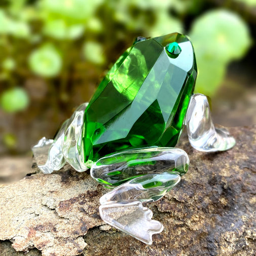 Green crystal frog figurine on a natural background