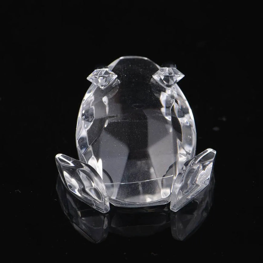 Crystal frog figurine on a black background