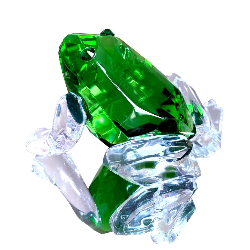 Green frog-shaped crystal on a white background