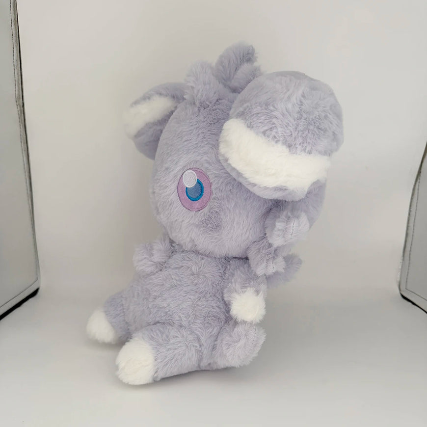 Gray plush toy with a circular emblem on a white background